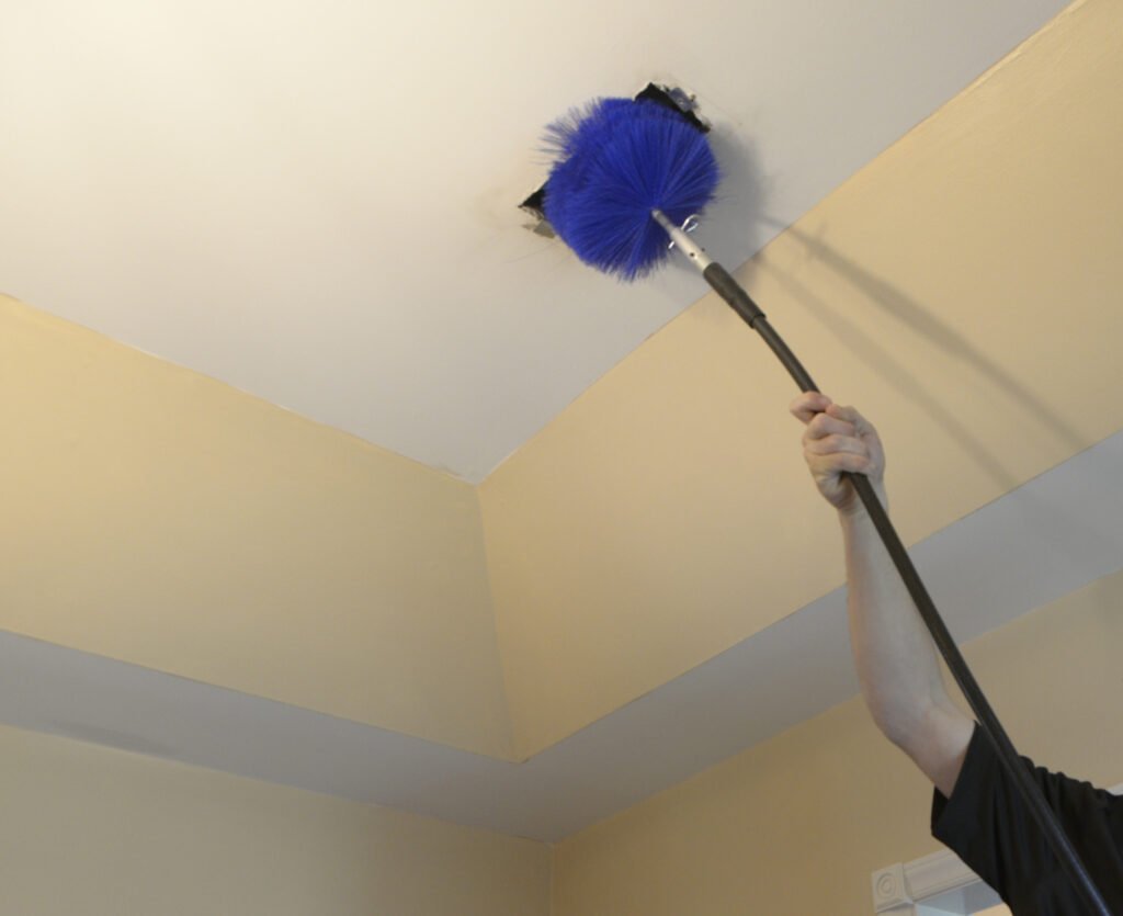 Small brush entering an opened air duct