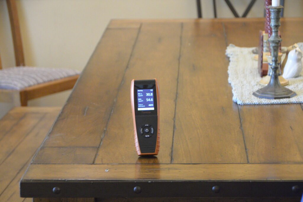Air testing meter placed on a table inside of a home